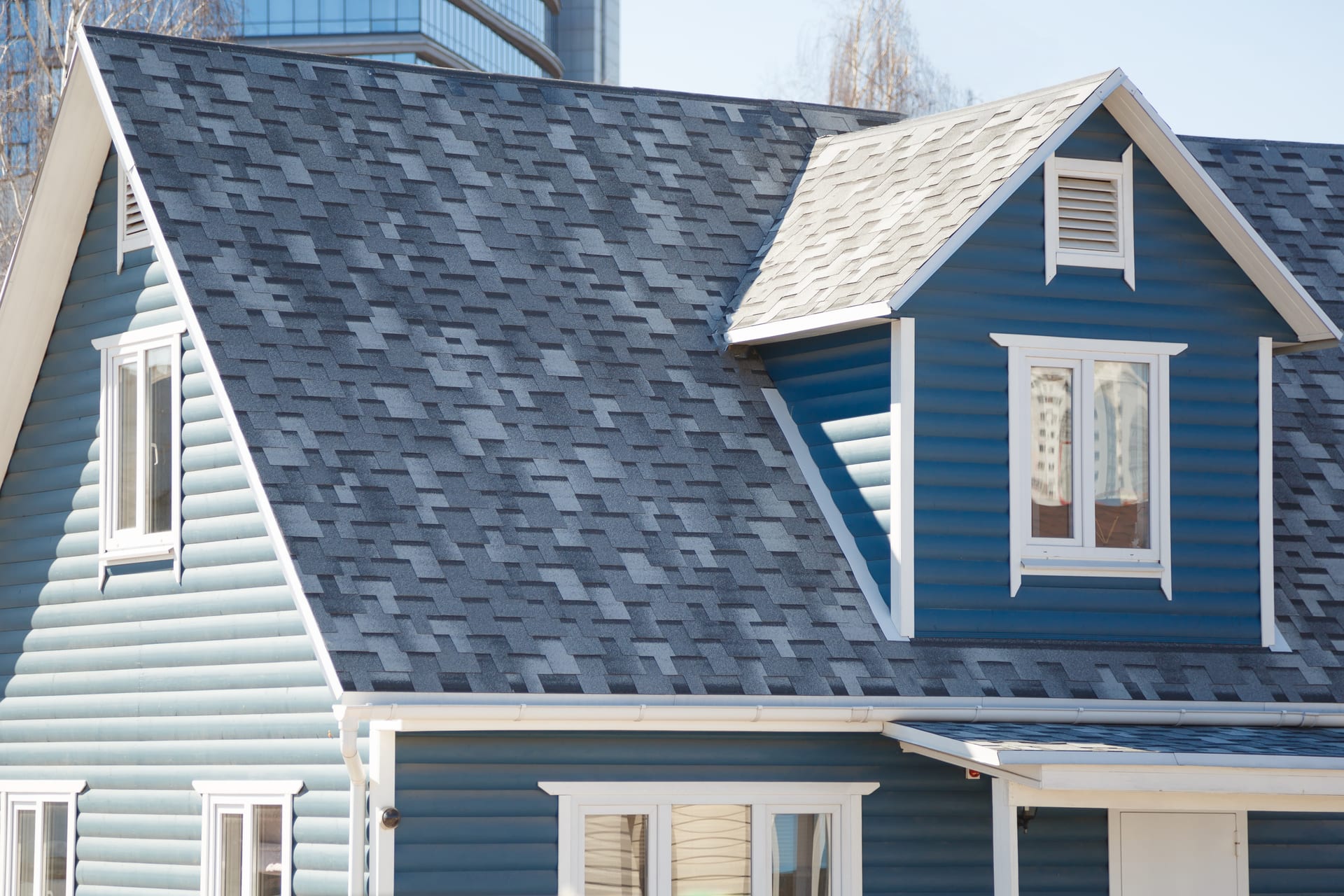 Florida home with a new gray architectural asphalt shingle roof by Best Florida Roofing