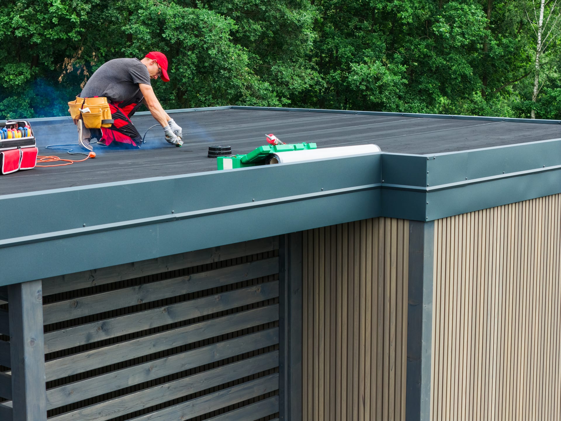 Roofer sealing a flat roof seam watertight on a Florida building by Best Florida Roofing
