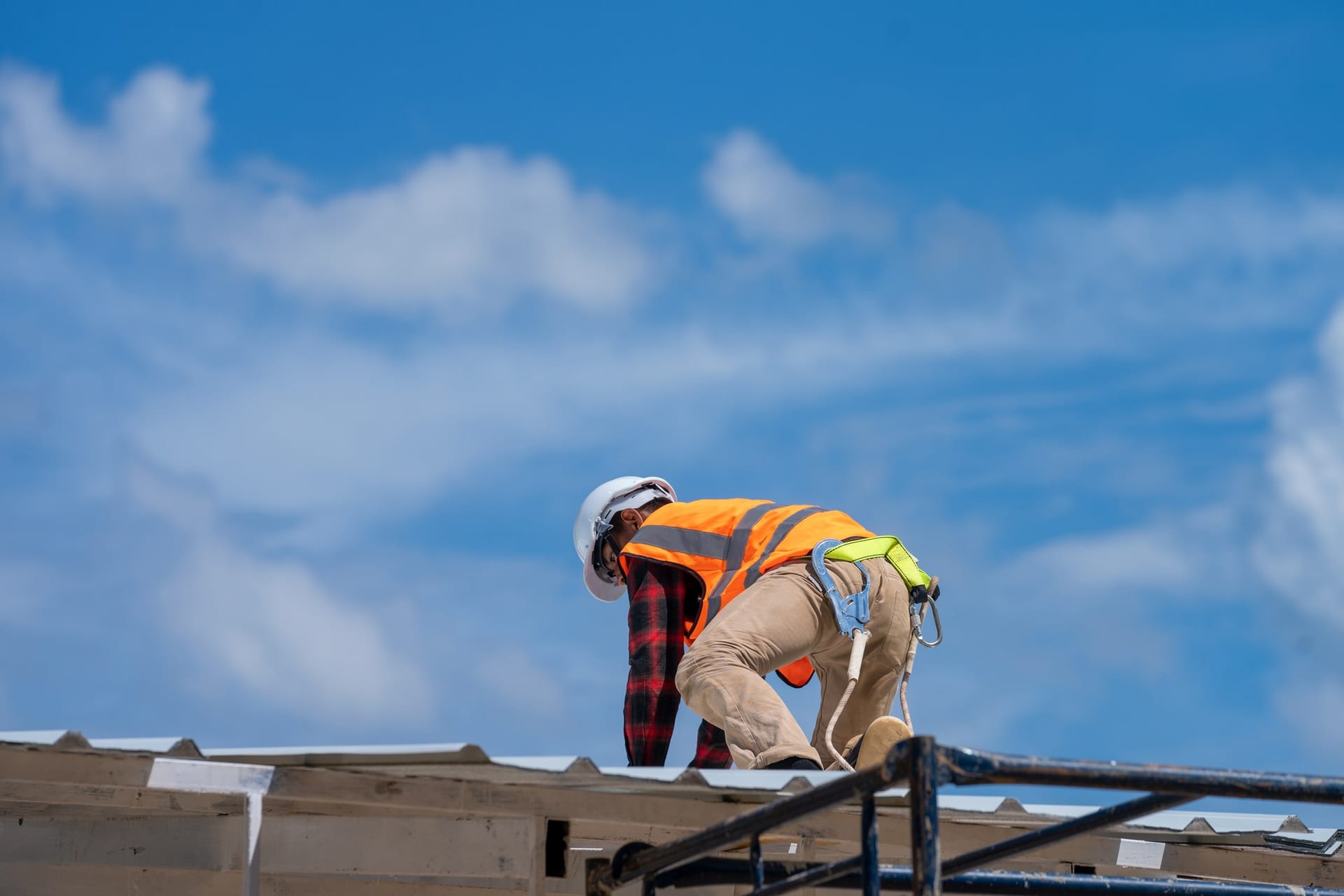 Roofer installing a standing-seam metal roof in Florida for Best Florida Roofing