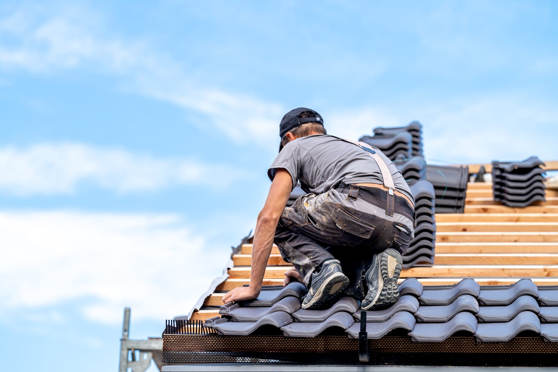 Tile roof installation against a blue sky in Florida by Best Florida Roofing
